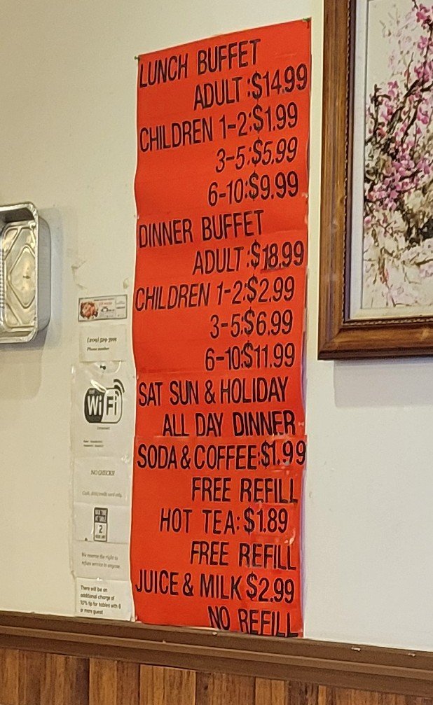 Rows of hot dishes inside a casual buffet restaurant.